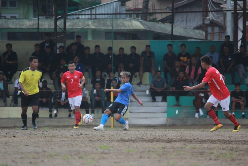 Kakhevi Assumi (blue jersey) taking a shot against Football Association Phek District (red jersey) during the first match of Dr T Ao Trophy 2022 at Imkongmeren Sports Complex, Mokokchung. (Photo: NFA Media Team)